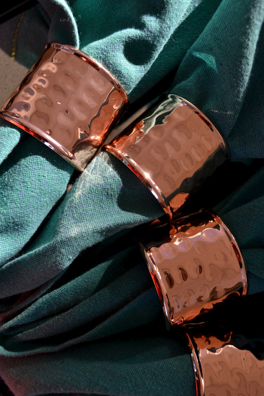 Hammered metal napkin rings, rose gold napkin rings, napkin ring set, metallic napkin ring set, napkin rings with napkins in them, home decor, zoomed in view