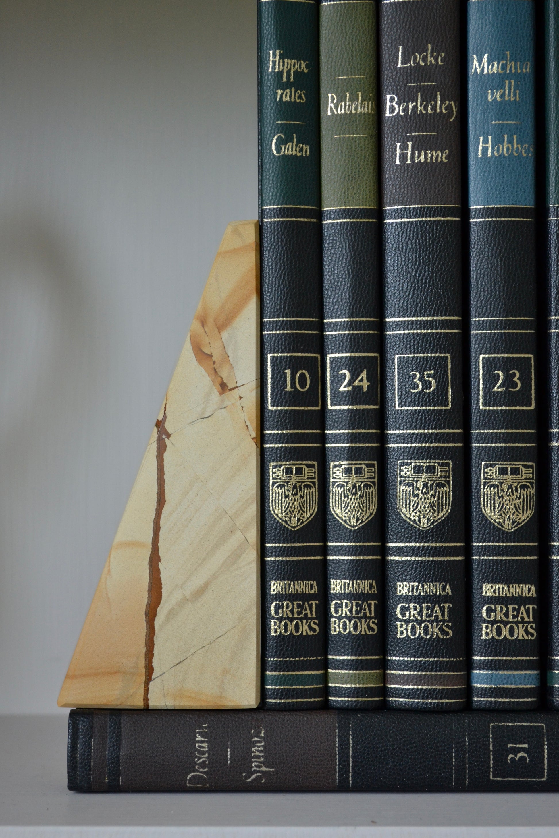 marble bookends, wedge shaped booked, neutral marble decor, black and white marble decor, shelf decoration, close up view