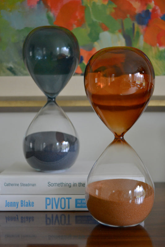 Hand-blown hourglass timer, blue hourglass, orange hourglass, sand timer, coffee table decor, shelf decor, front view