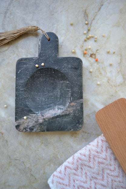 Stone spoon rest, black marble, jute tassel, marble kitchen home decor, overhead view with spoon and towel