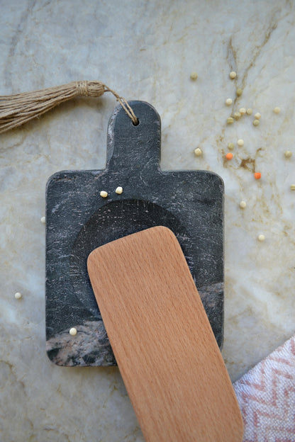 Stone spoon rest, black marble, jute tassel, marble kitchen home decor, overhead view with spoon